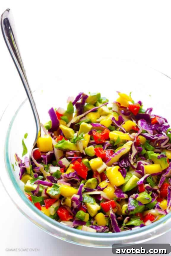 A colorful array of diced ingredients for the mango slaw, including mango, red pepper, red onion, and cilantro, ready to be mixed.