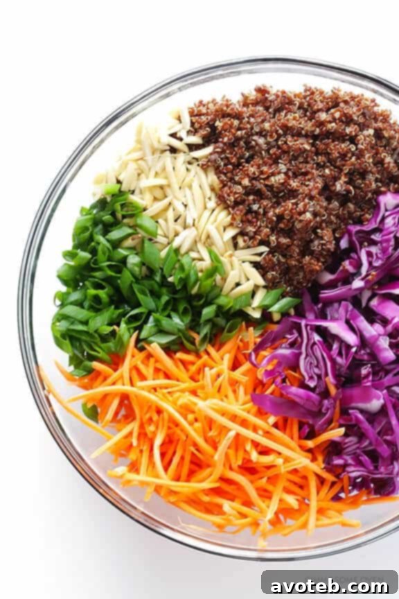 Fresh ingredients for Easy Asian Quinoa Salad: cabbage, carrots, quinoa, green onions, almonds
