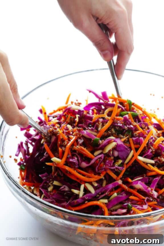 Pouring vinaigrette over Asian Quinoa Salad ingredients
