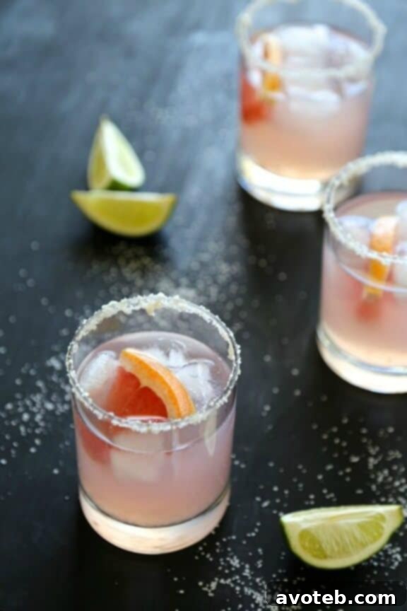15 Must Try Margarita Creations 4 A vibrant grapefruit margarita artfully garnished with a distinctive ginger salt rim, exuding zest and aroma.