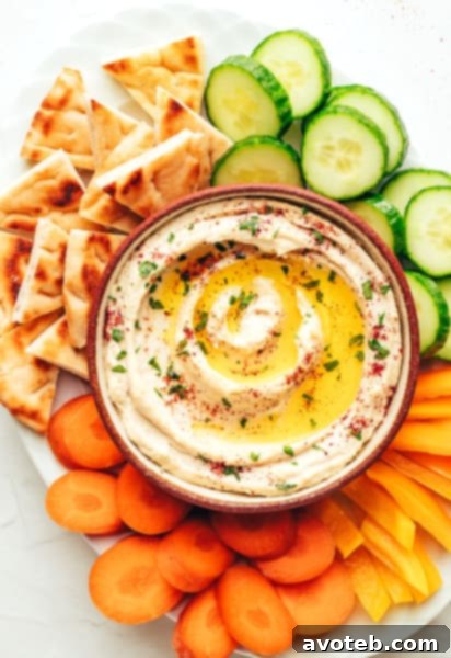 Creamy homemade hummus with olive oil and fresh parsley.