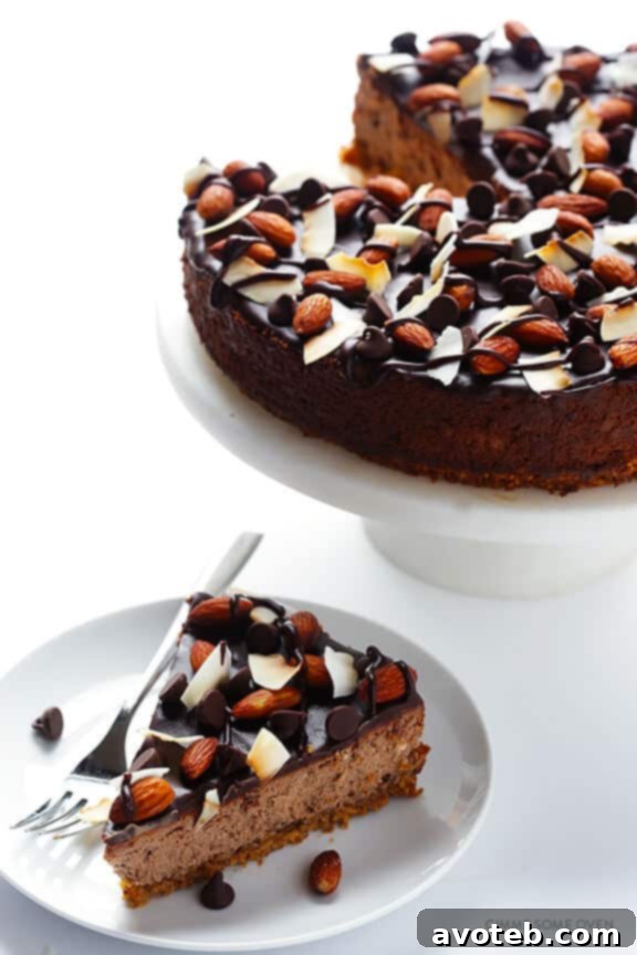 Almond Joy Cheesecake with an easy almond crust, naturally gluten-free. A delicious combination of chocolate, almonds and coconut.