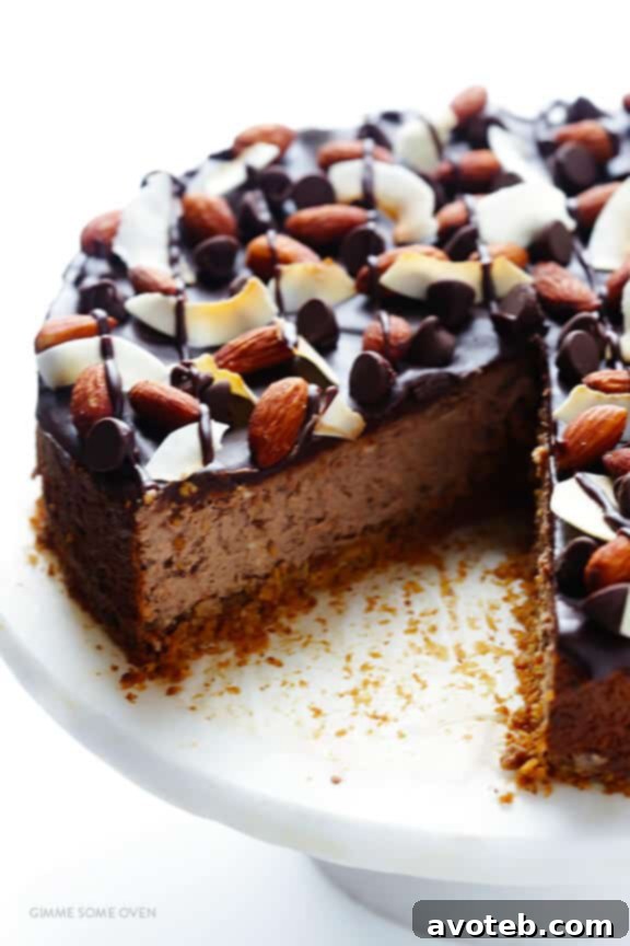 A decadent slice of Almond Joy Cheesecake on a plate, highlighting its creamy texture and abundant toppings.