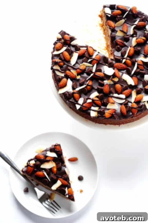 A whole Almond Joy Cheesecake, showcasing its rich chocolate filling and an elegant almond crust.