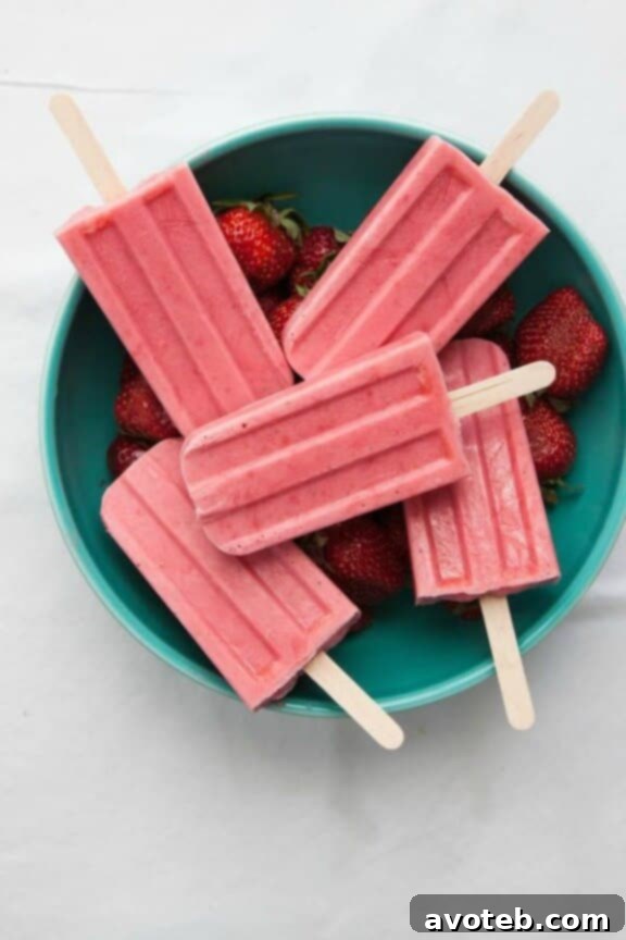 15 Irresistible Strawberry Delights 5 4-Ingredient Strawberry Yogurt Popsicles, a simple and healthy frozen treat.