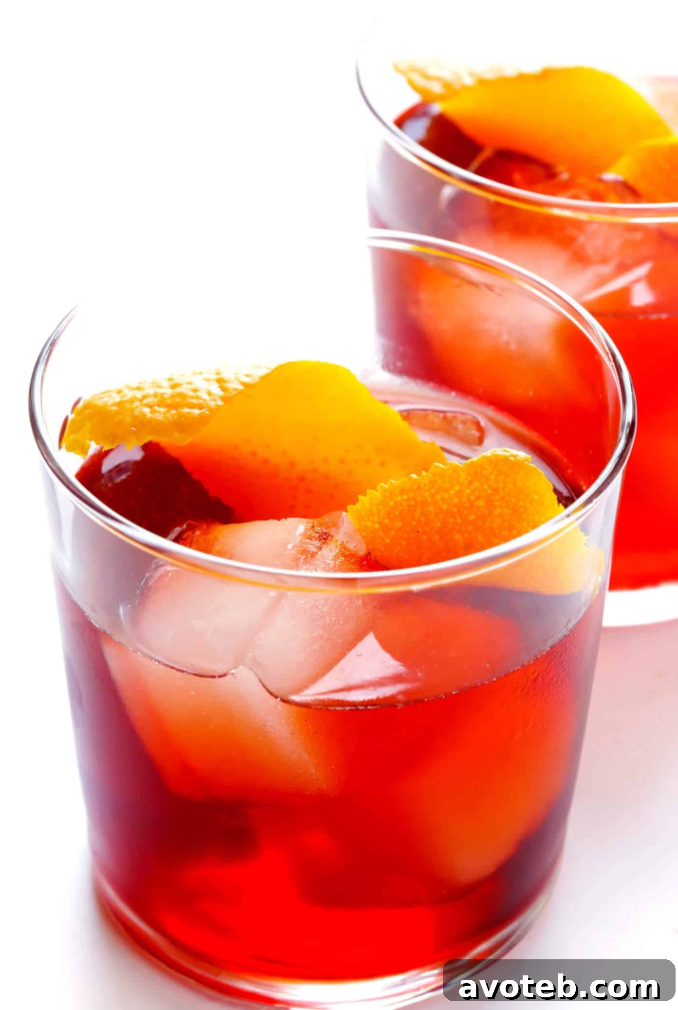 Discover the quintessential Negroni: a refreshing, bitter-sweet classic cocktail made with Campari, gin, and sweet vermouth, perfect for any season or occasion. Classic Negroni Cocktail with a vibrant orange slice, served over ice in a rocks glass