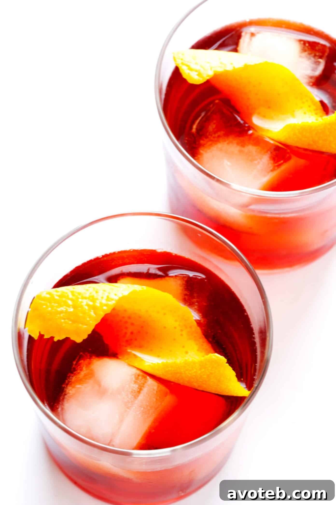 Experience the vibrant color and refreshing taste of a perfectly crafted classic Negroni cocktail, ready to be enjoyed. A perfectly prepared classic Negroni cocktail, showcasing its vibrant red hue and an orange peel garnish