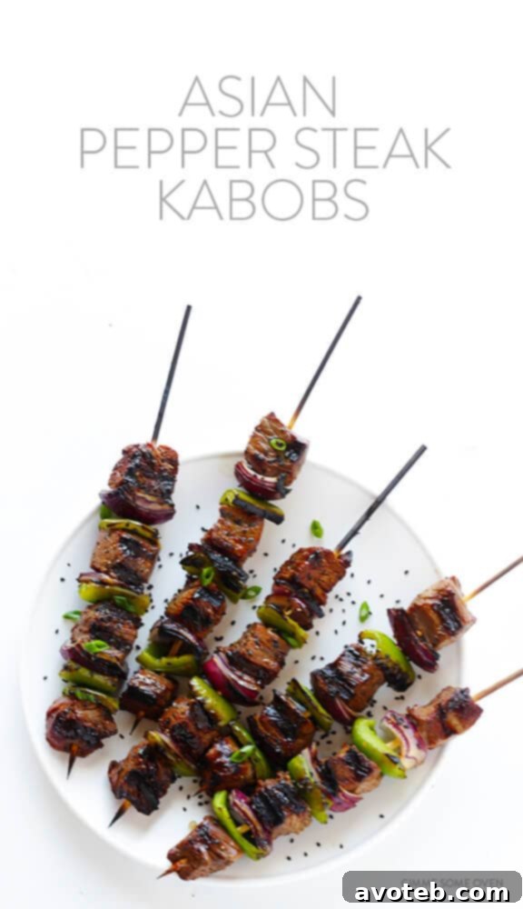 Close-up of a perfectly grilled Asian Pepper Steak Kabob, showcasing tender steak, charred peppers, and onions
