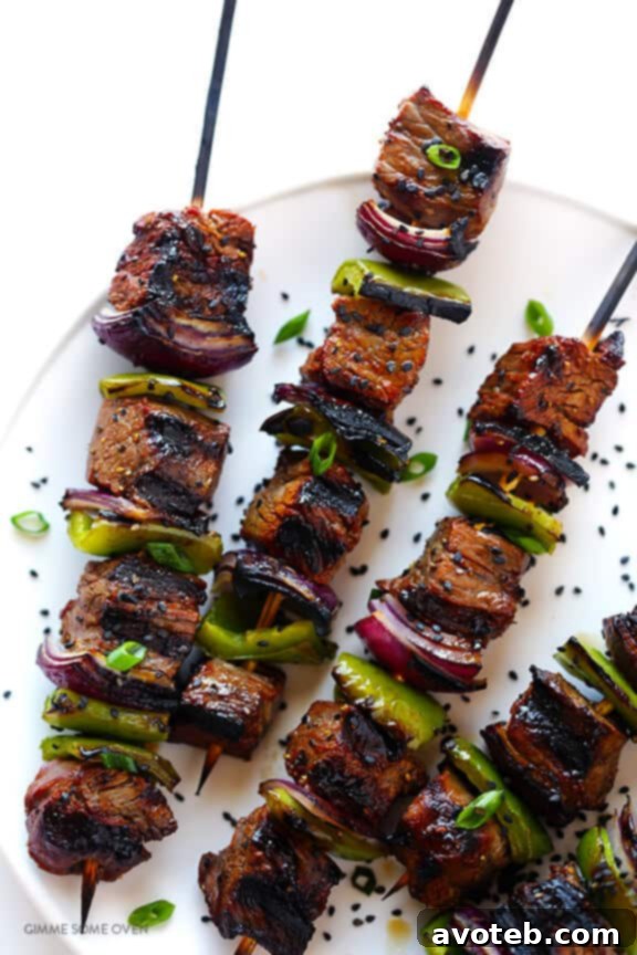 Grilling Asian Pepper Steak Kabobs on a hot grill for a smoky finish