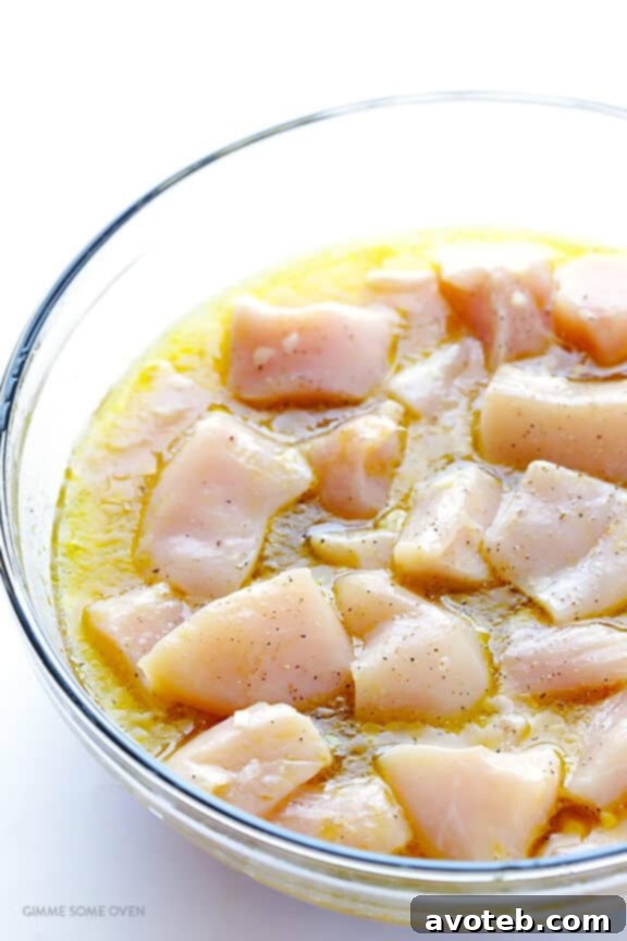 Chicken marinating in tequila lime mixture in a bowl
