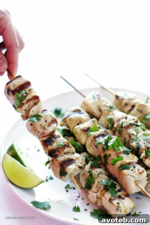 Cooked Tequila Lime Chicken Kabobs garnished with cilantro and lime