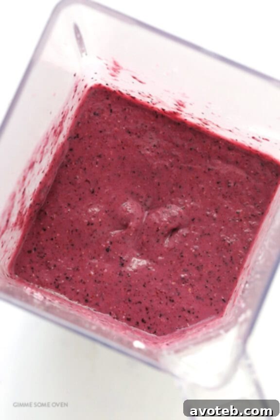 Liquid Blueberry Muffin 5 Blender with Blueberry Muffin Smoothie ingredients being mixed, showing the transformation into a smooth, purple beverage.
