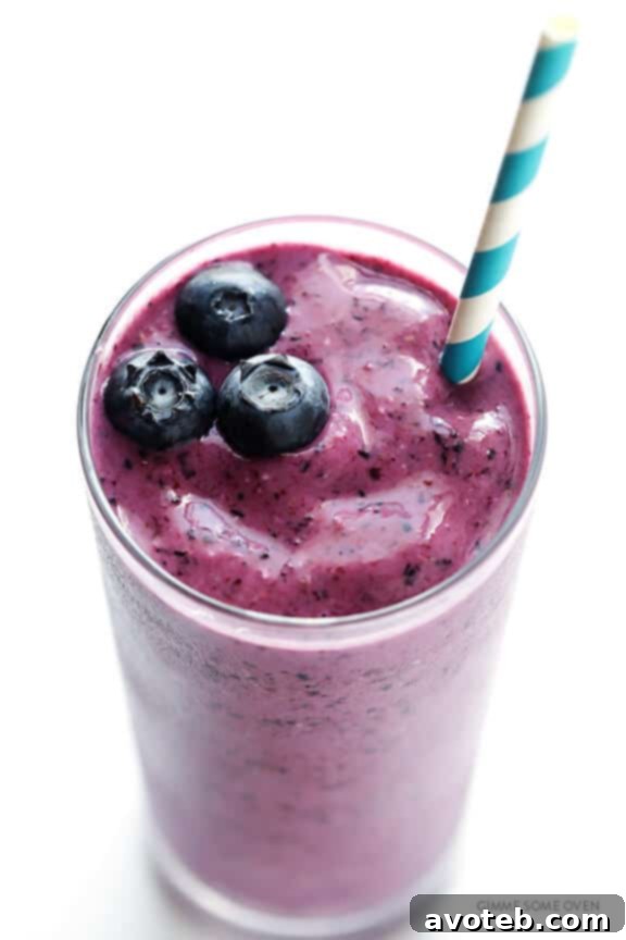 Liquid Blueberry Muffin 6 A glass of Blueberry Muffin Smoothie, garnished with fresh blueberries, ready to be enjoyed.