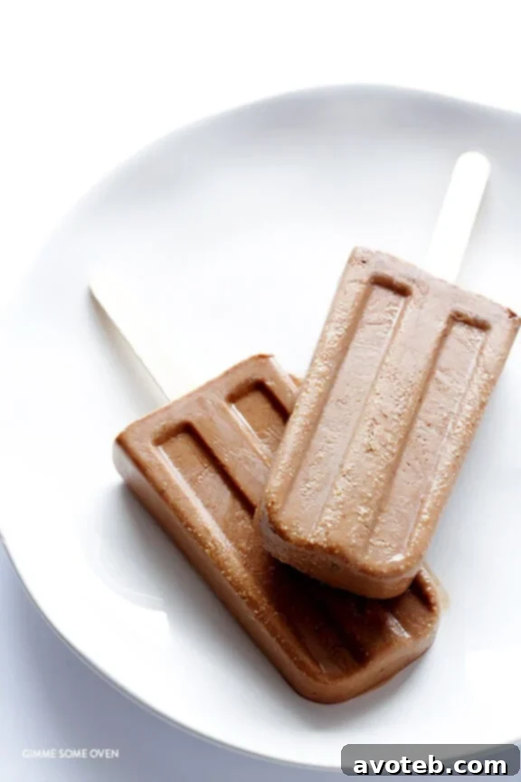 A batch of homemade Chocolate Peanut Butter Fudge Pops in molds and ready to enjoy.