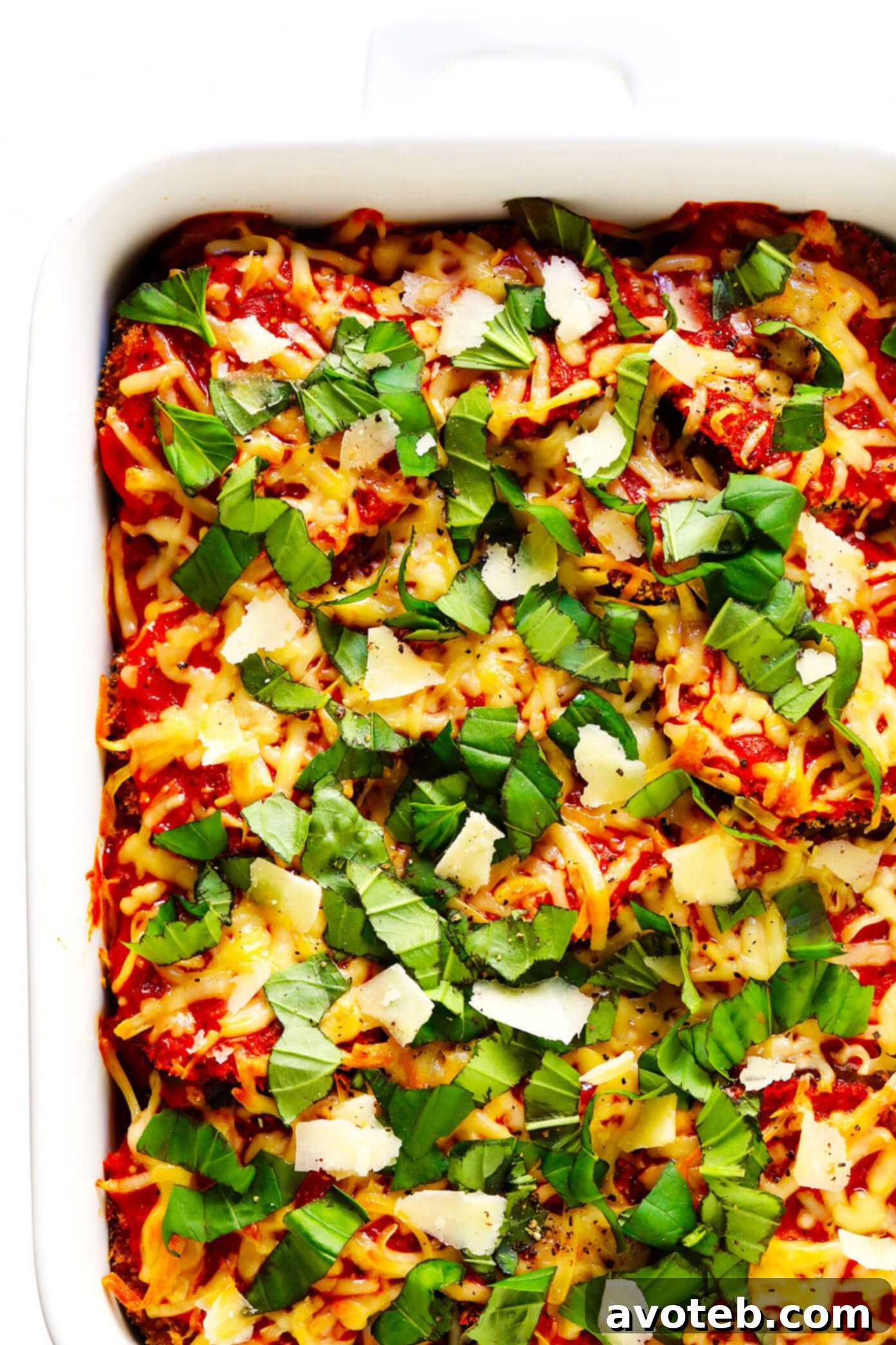 This Baked Eggplant Parmesan recipe is lightened up a bit with Panko-crusted baked (instead of fried) roasted eggplant, and layered with marinara tomato sauce, mozzarella cheese, fresh basil, and lots and lots of Parmesan. It's the perfect vegetarian casserole for Italian night, and always winner! | gimmesomeoven.com #eggplant #parmesan #vegetarian #casserole #glutenfree #italian #comfortfood #lasagna Healthy Baked Eggplant Parmesan Recipe with Fresh Basil Garnish