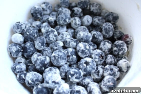 Ingredients for Blueberry Zucchini Bread laid out, including fresh zucchini and blueberries