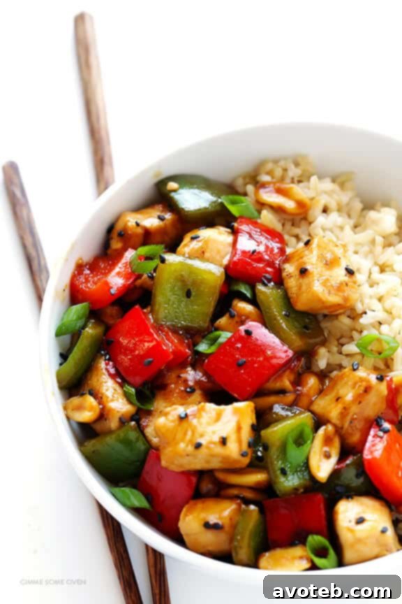 Fiery Peanut Kung Pao Chicken 6 Kung Pao Chicken served with rice, garnished with green onions and sesame seeds, an inviting and satisfying meal.