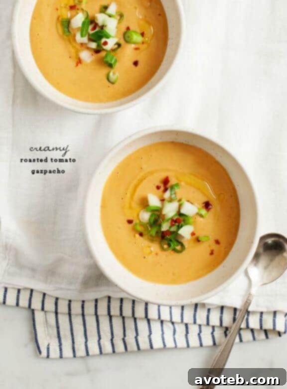 A creamy, rich Roasted Tomato Gazpacho, offering a warm depth of flavor in a chilled soup, a unique twist on a classic.