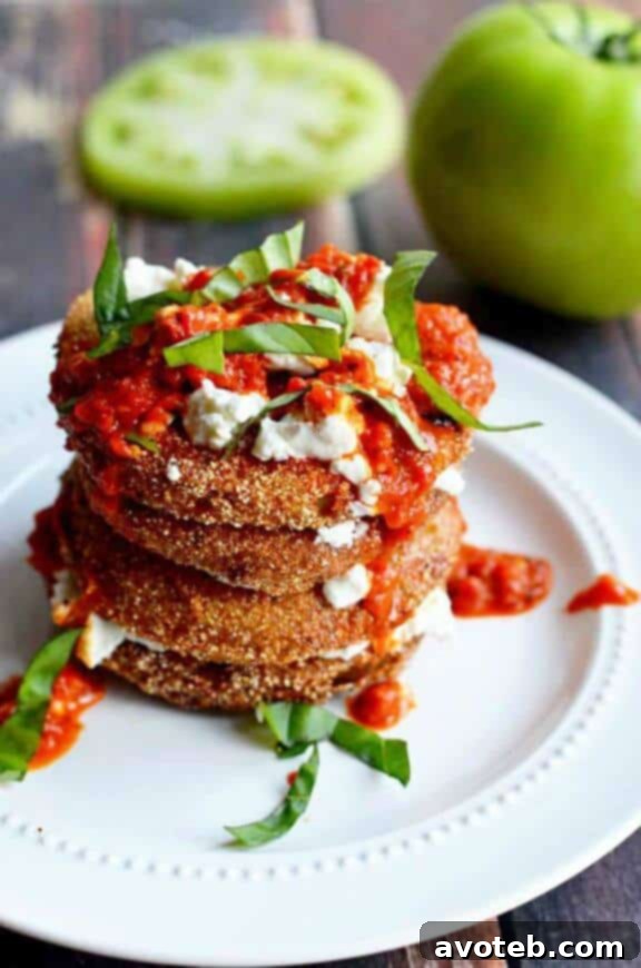 Fried Green Tomatoes with Goat Cheese and Roasted Red Pepper Vinaigrette, a sophisticated and flavorful appetizer or side dish.
