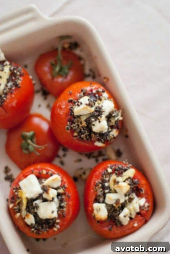 Mediterranean Stuffed Tomatoes with Quinoa, a healthy and flavorful vegetarian main course, elegantly presented.