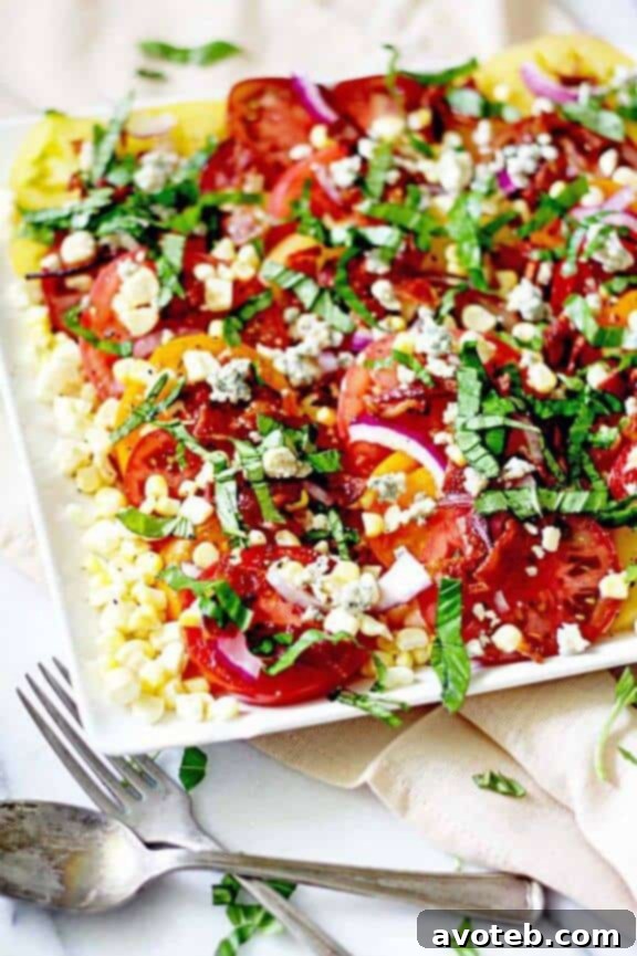 A beautiful Heirloom Tomato and Bacon Summer Salad, featuring colorful heirloom tomatoes, crispy bacon, and fresh herbs, perfect for a light meal.