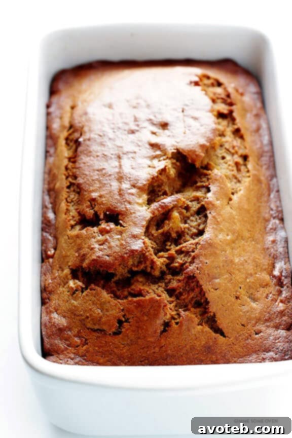 Combining wet ingredients in another bowl for banana bread.