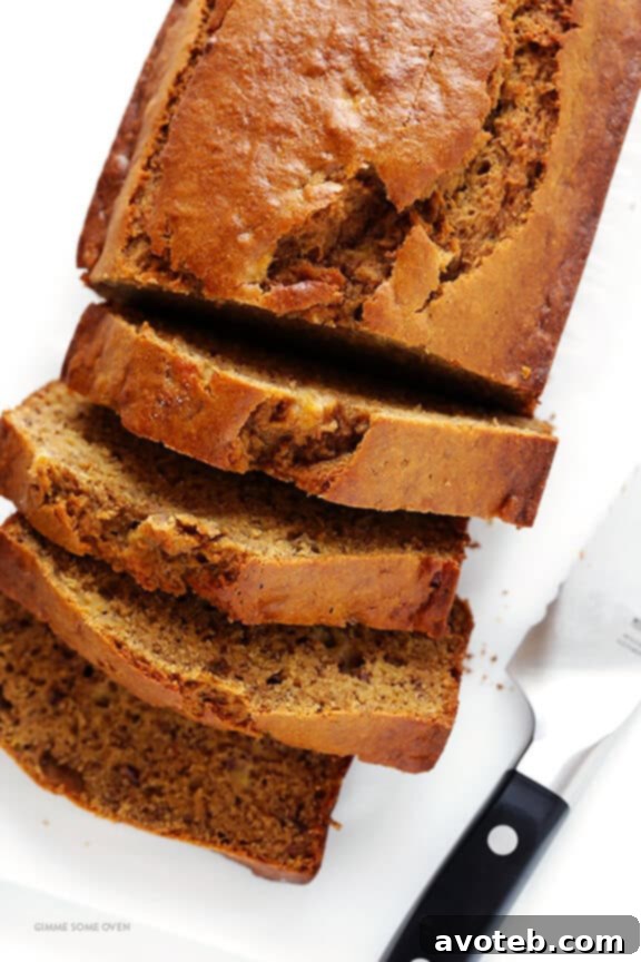 A slice of banana bread with a bite taken out, showing its moist interior.