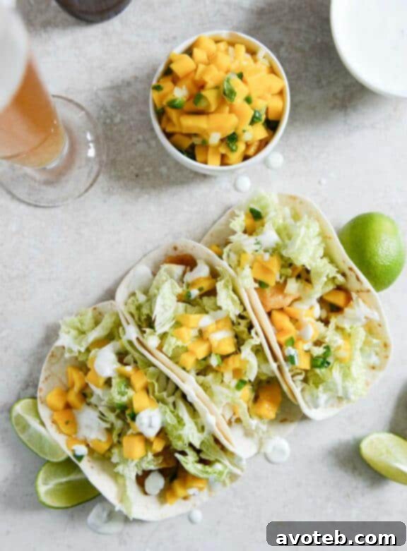 15 Creative Taco Recipes 5 Beer Battered Fish Tacos with Margarita Mango Salsa and Jalapeño Crema | A vibrant and zesty fish taco recipe from How Sweet It Is.