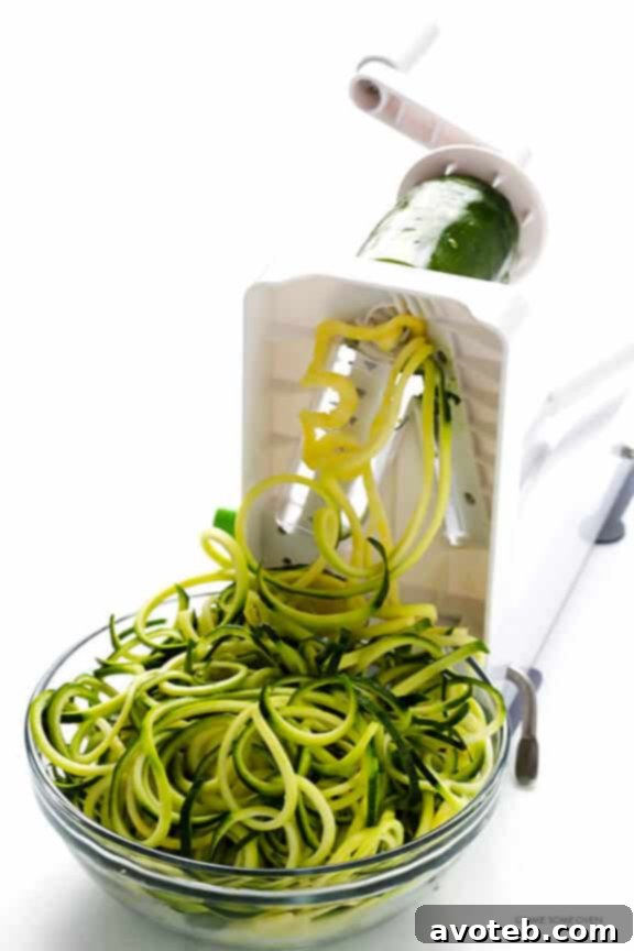 Freshly spiralized zucchini noodles ready for cooking. Zoodles Marinara is a super easy, delicious, healthy, vegetarian, and gluten-free meal.