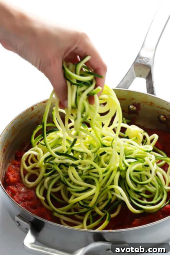 Thick, simmering marinara sauce, essential for flavorful Zoodles Marinara, made with high-quality DeLallo ingredients.