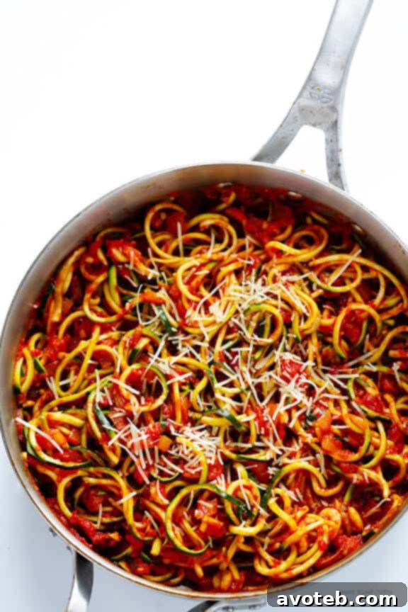 Zucchini noodles tossed in a rich marinara sauce, creating a quick and healthy Zoodles Marinara dish.