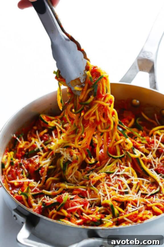 Finished Zoodles Marinara dish, generously topped with freshly grated Parmesan cheese for extra flavor.