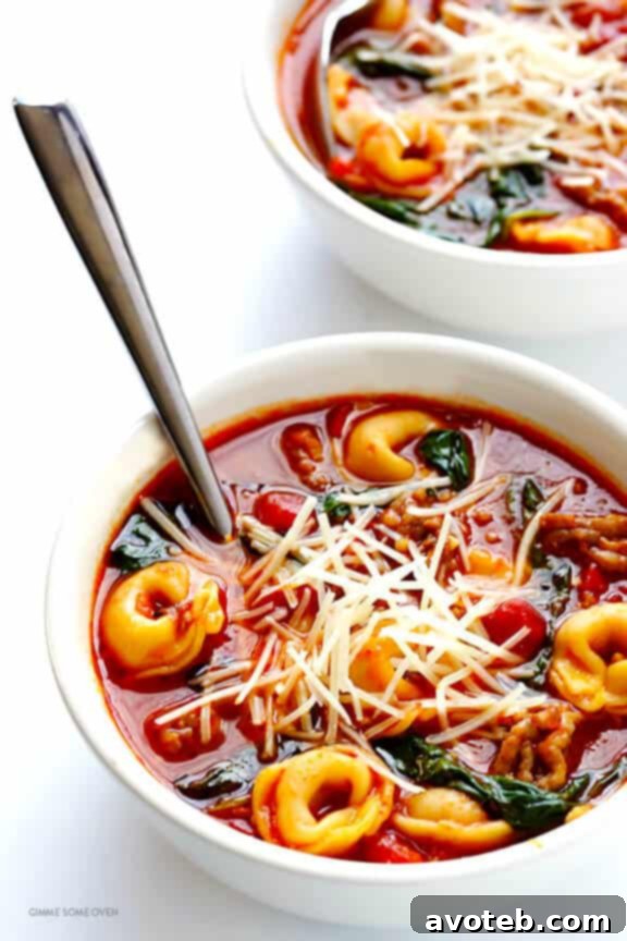 Delicious and comforting Tortellini Soup with Italian Sausage, Spinach, and Tomatoes – perfect for a quick, hearty meal. | gimmesomeoven.com