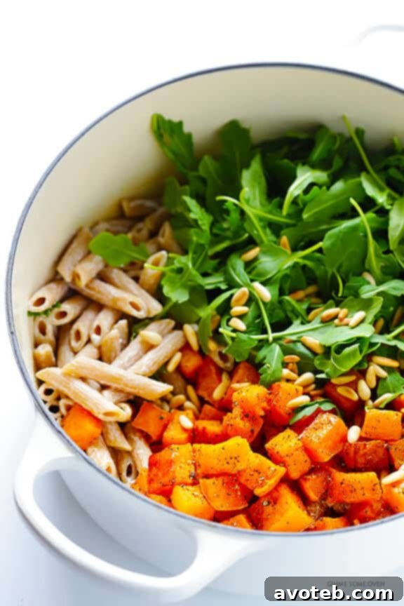 5-Ingredient Butternut Squash Pasta with Arugula and Goat Cheese 5 Overhead shot of the pasta ingredients before mixing, including roasted butternut squash, fresh arugula, and pine nuts