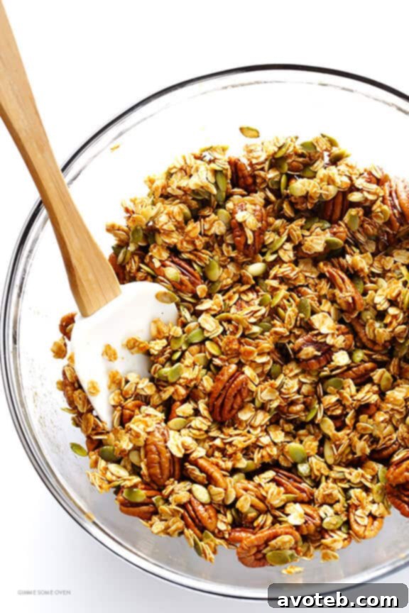 Mixing oats, nuts, and pumpkin spice sauce for granola