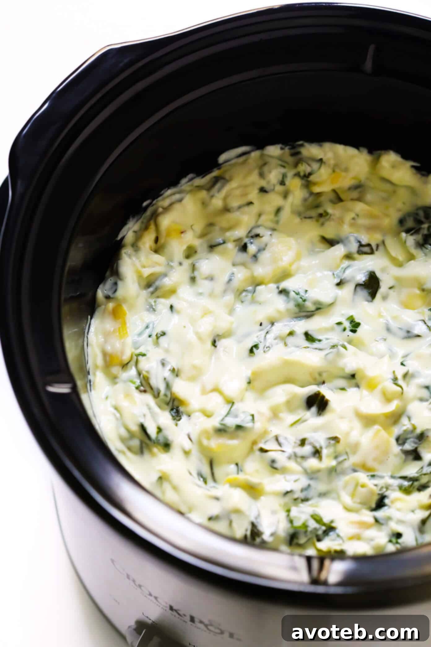 The Best Slow Cooker Spinach Artichoke Dip: Rich, Creamy, and Easy for Parties Delicious and Creamy Slow Cooker Spinach Artichoke Dip, ready to serve with dippers