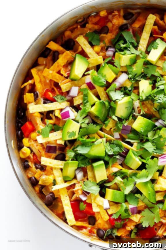 Easy Chicken Enchilada Skillet served in a tortilla bowl with fresh toppings