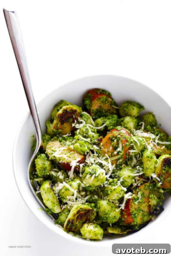 Gnocchi, chicken sausage, and Brussels sprouts coated in homemade Kale Basil Pesto in a large pot