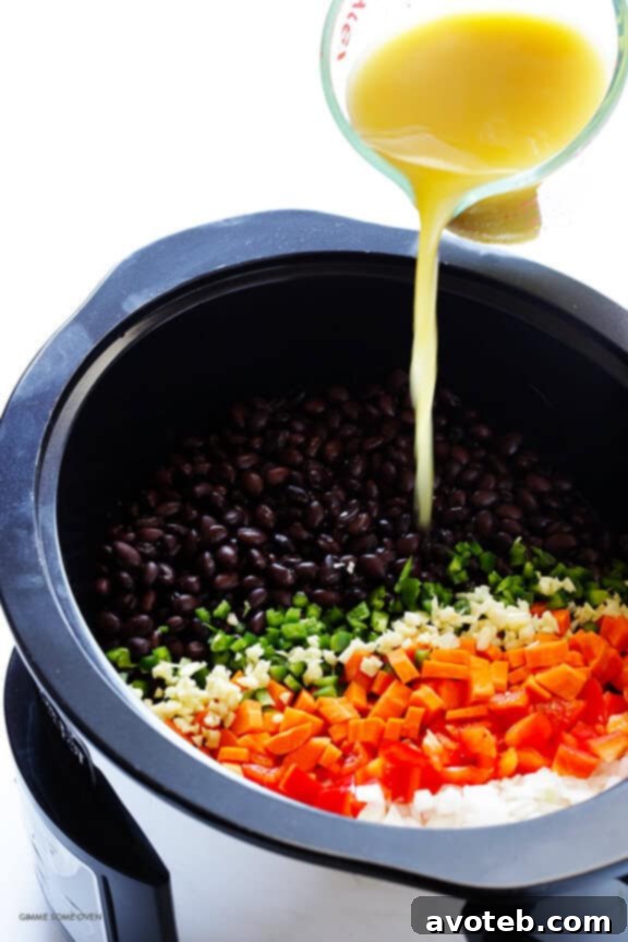 Fresh ingredients for Slow Cooker Black Bean Soup: onions, carrots, bell peppers, and jalapeños.