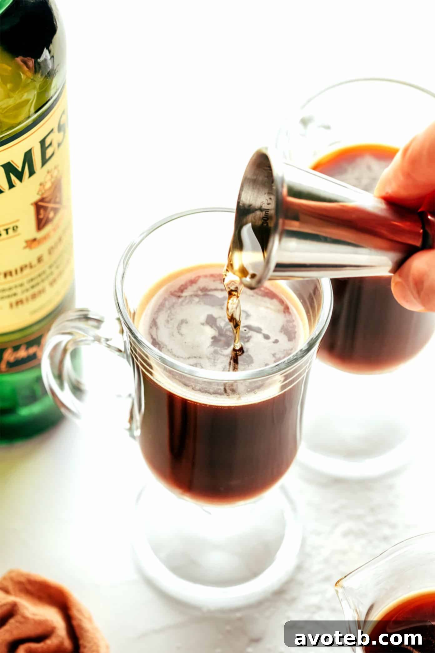 Emerald Isle Elixir 3 Preparing Irish coffee by mixing ingredients in a glass mug.