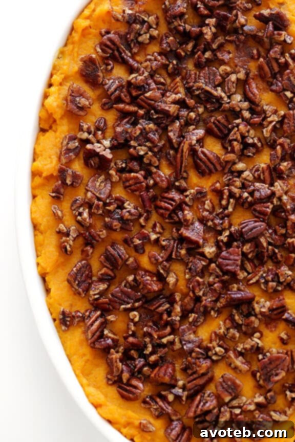 Healthier Sweet Potato Casserole -- naturally sweetened with a hint of maple syrup, and topped with cinnamon pecans