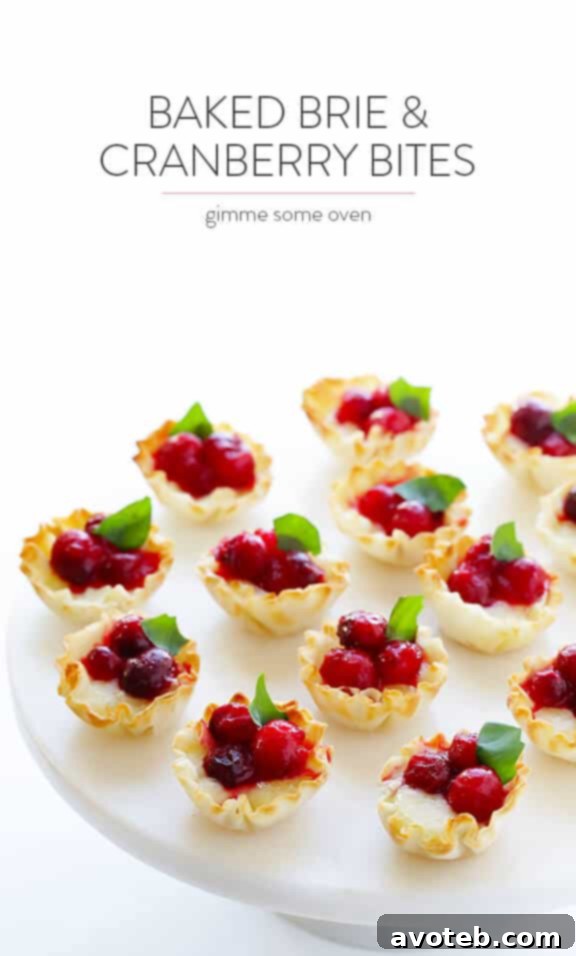 Gooey Cranberry Brie Bites 14 A beautifully arranged platter of Super-Easy Cranberry Baked Brie Bites, ready to be served and enjoyed at a festive gathering