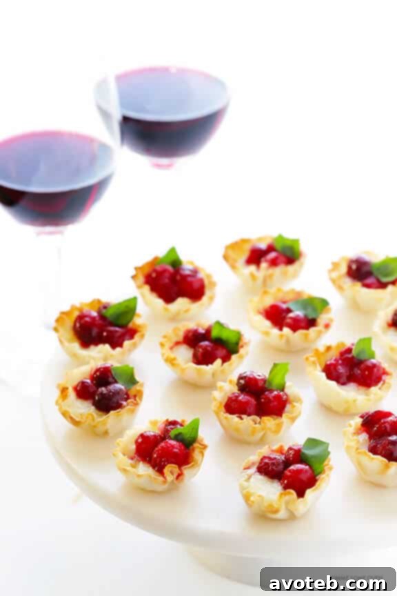 Gooey Cranberry Brie Bites 6 A Bota Box of red wine being poured into a glass, with other glasses and a relaxed gathering in the background
