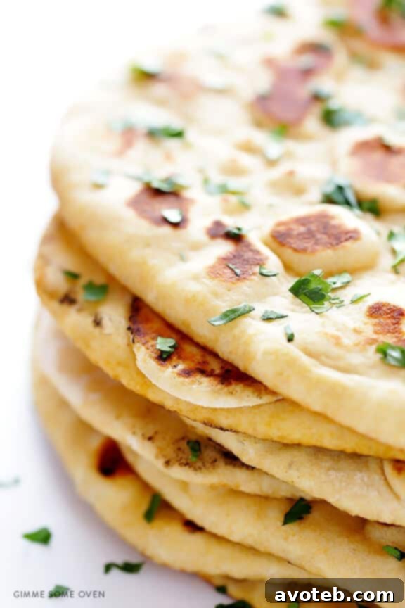 Learn how to make homemade naan (Indian flatbread) with this simple and delicious recipe! | gimmesomeoven.com