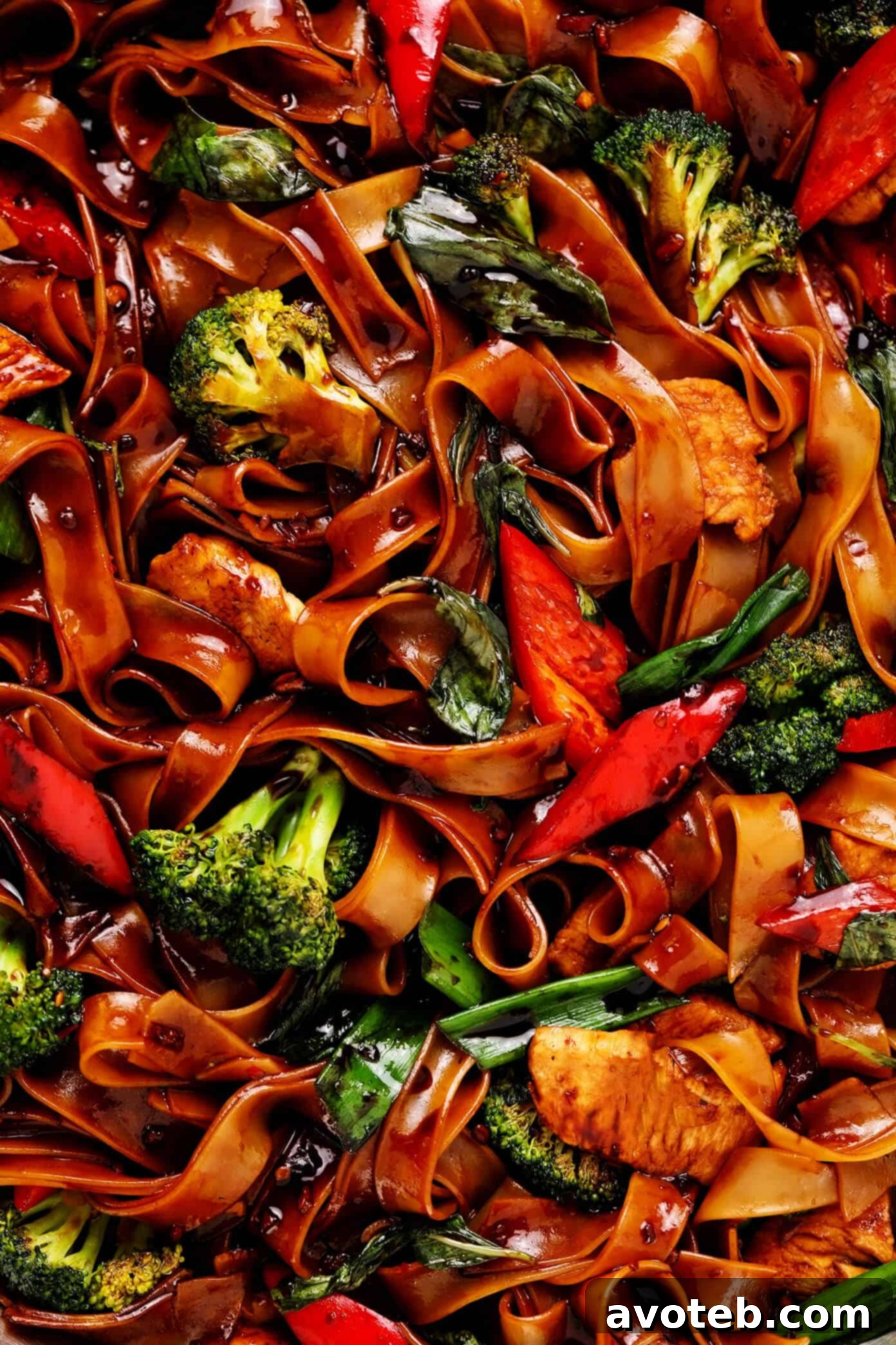 Close-up of Thai Drunken Noodles (Pad Kee Mao) with tender chicken, crisp broccoli, and bell peppers.