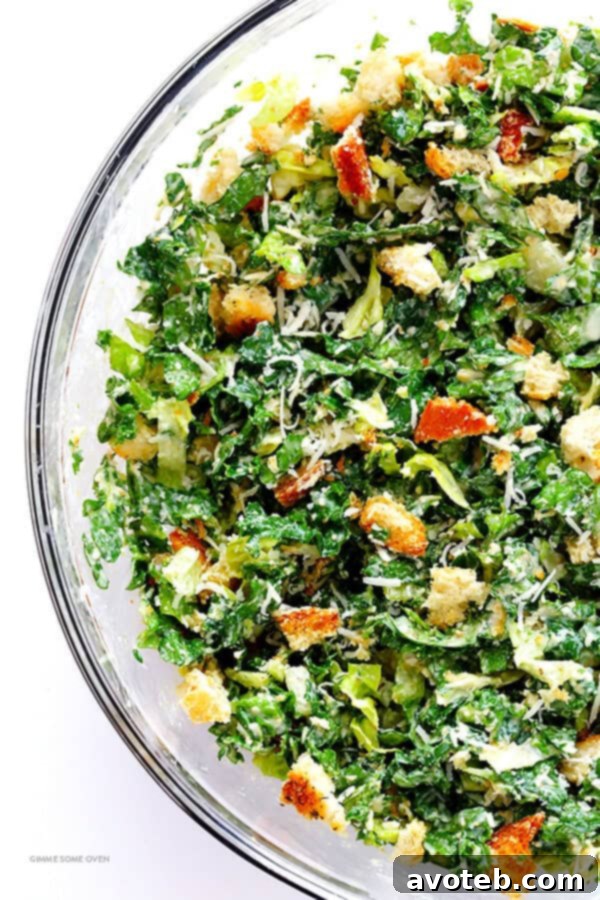Mixing fresh kale, romaine, parmesan, and lime Caesar dressing for a delicious salad