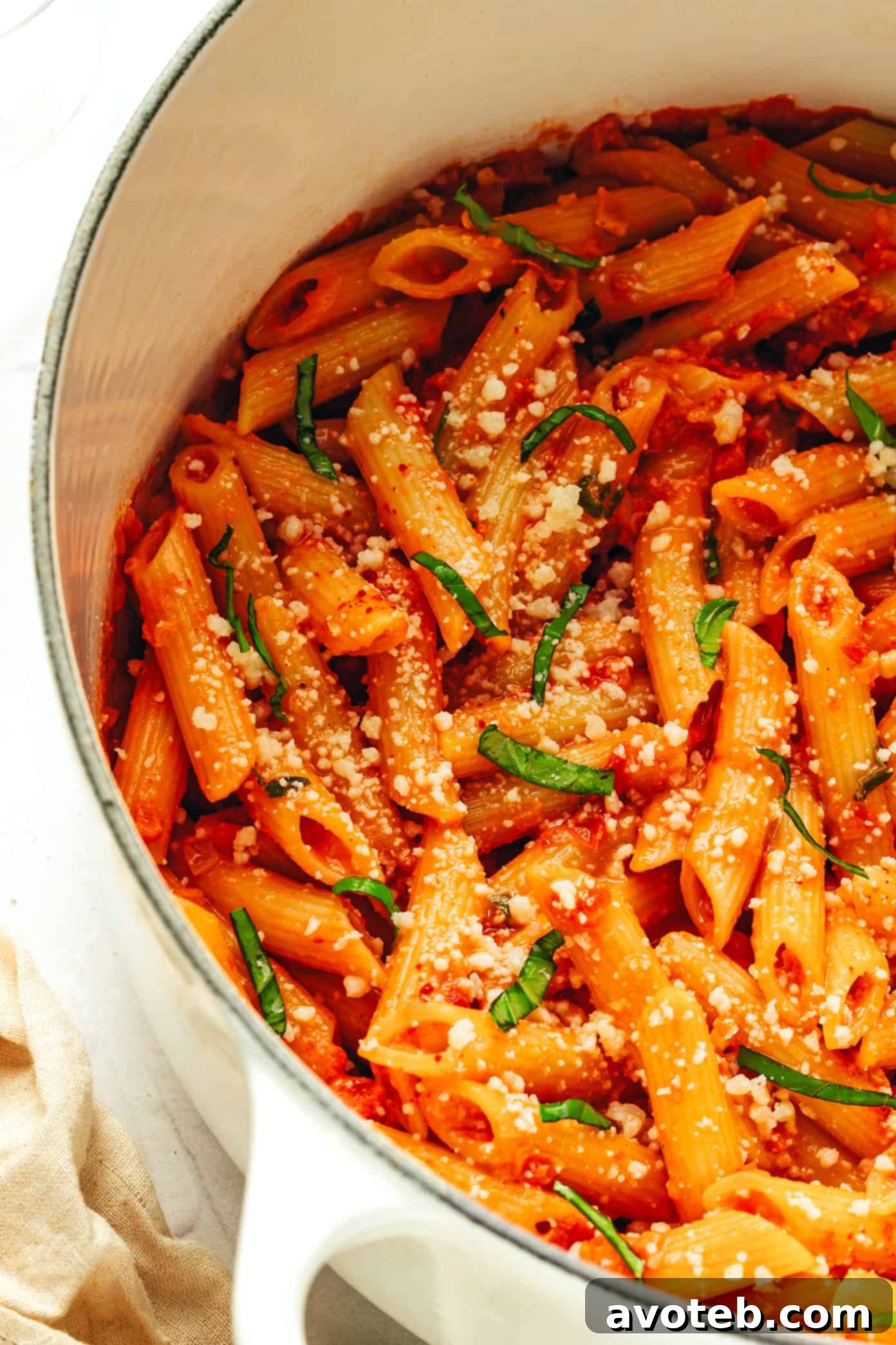Velvety Vodka Cream Penne 6 Close-up of the Penne Alla Vodka sauce being tossed with cooked penne pasta.