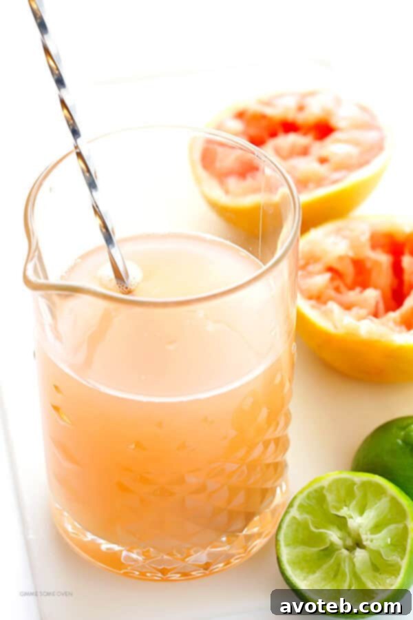 Ruby Red Margaritas 5 Hands juicing fresh grapefruit and lime, preparing the citrus base for the margarita cocktail.