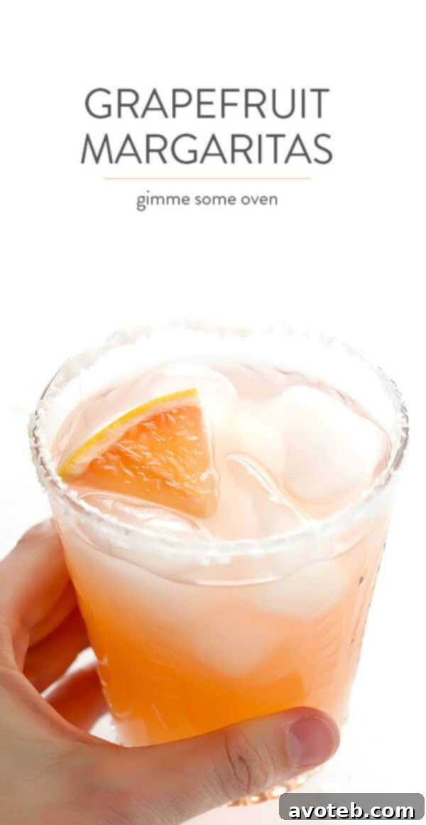 Ruby Red Margaritas 9 Two Grapefruit Margaritas with lime and grapefruit wedges, ready for serving.