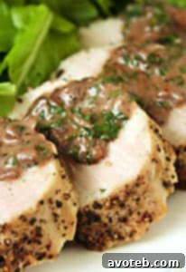 Pork Tenderloin with Burgundy Peppercorn Sauce on a serving plate